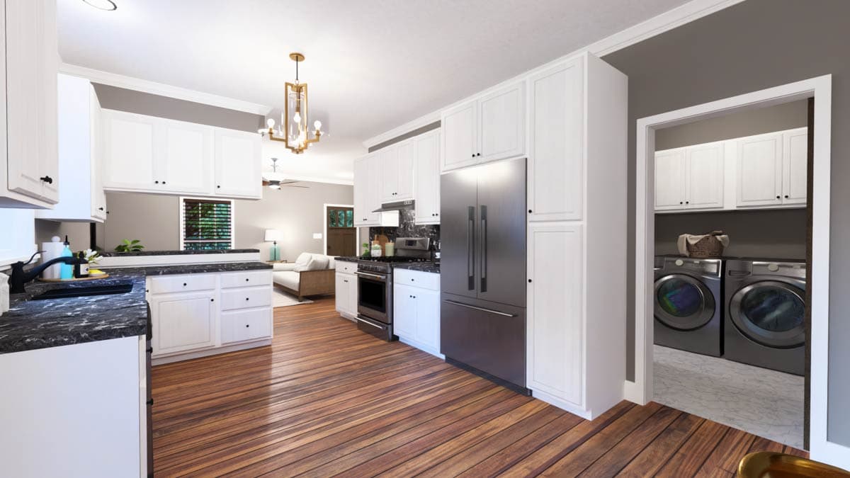 Modern kitchen with white cabinets, dark countertops, stainless steel appliances, and adjacent laundry room with washer and dryer.