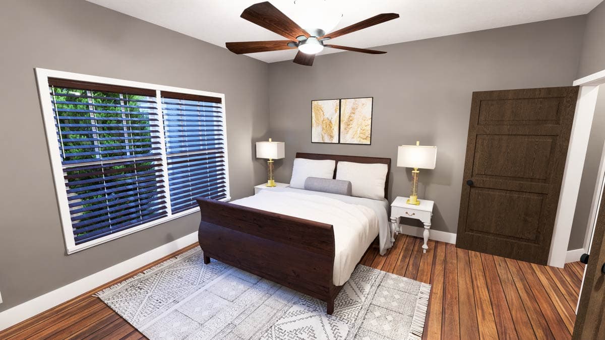 Bedroom interior view with queen bed, large window with blinds, dark wood door, ceiling fan, and wood flooring.