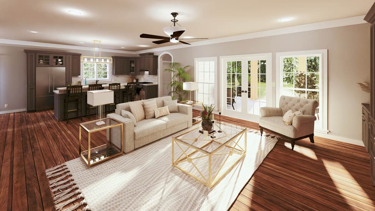 Open concept living area with kitchen island, seating area featuring a sofa and armchair, and French doors leading outdoors.