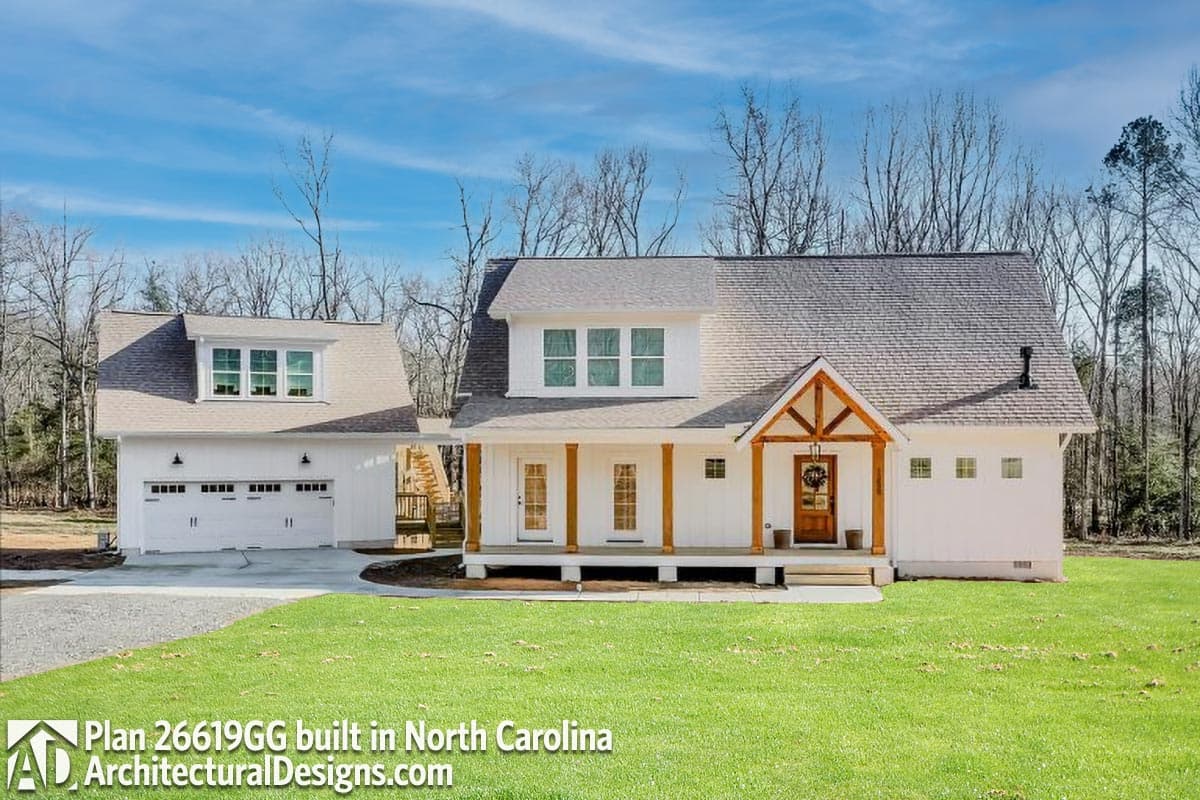 Modern farmhouse house plan exterior with a covered porch, prominent gables, dormer, and attached garage.