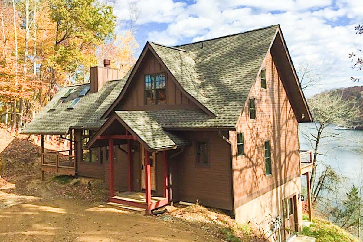 House plan exterior: Two-story lodge-style home with prominent gables, dormers, and a covered front porch.
