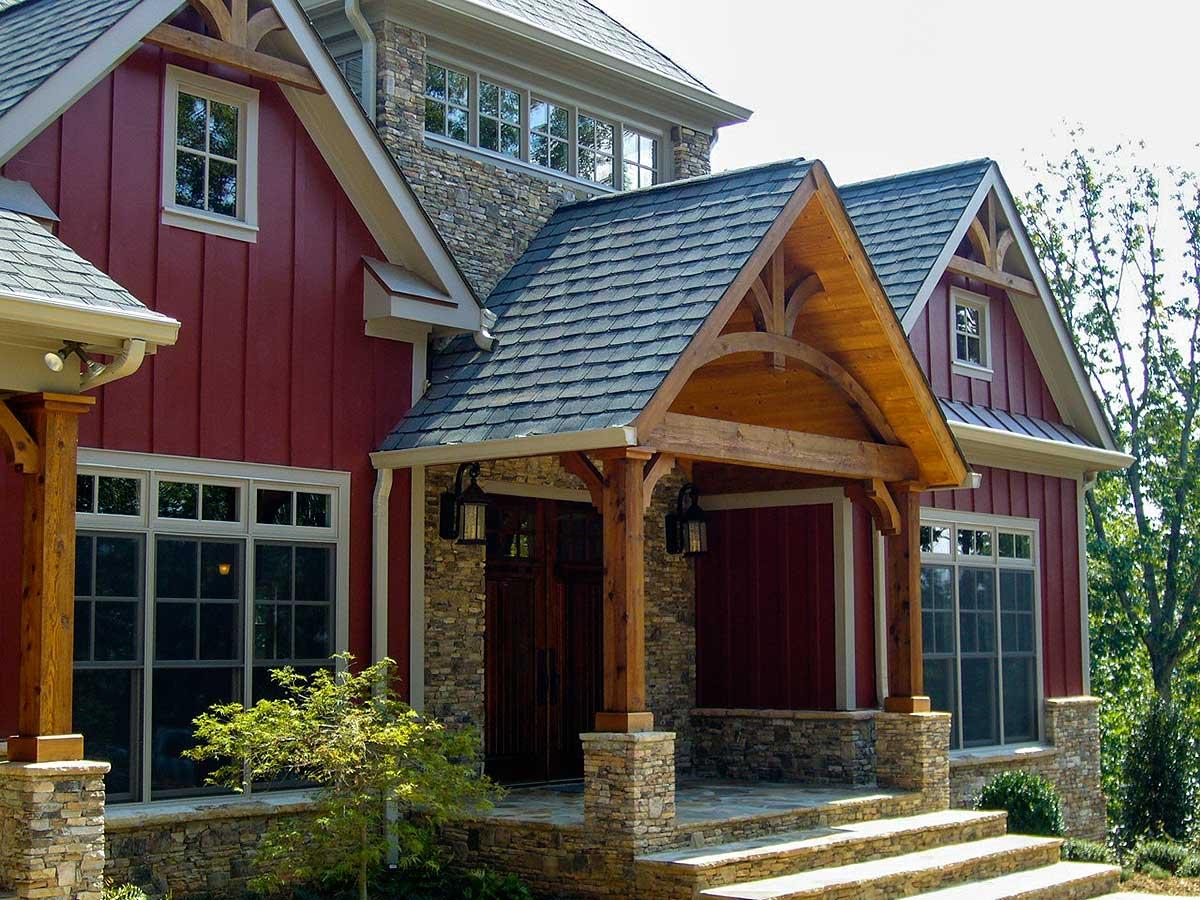 House plan exterior with deep eaves, stone foundation, board and batten siding, and a prominent wood-framed covered entry.