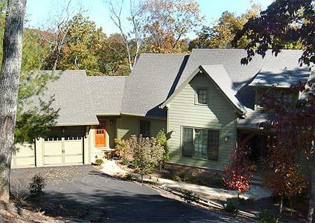 House plan exterior of a multi-story home with a visible side-entry garage, prominent gables, and varied rooflines.