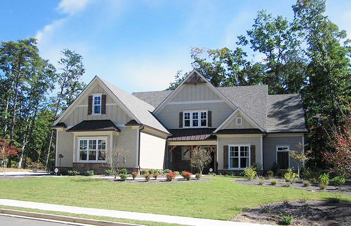 House plan exterior: Craftsman style, two stories, with gables, dormers, a covered porch, and multiple rooflines.