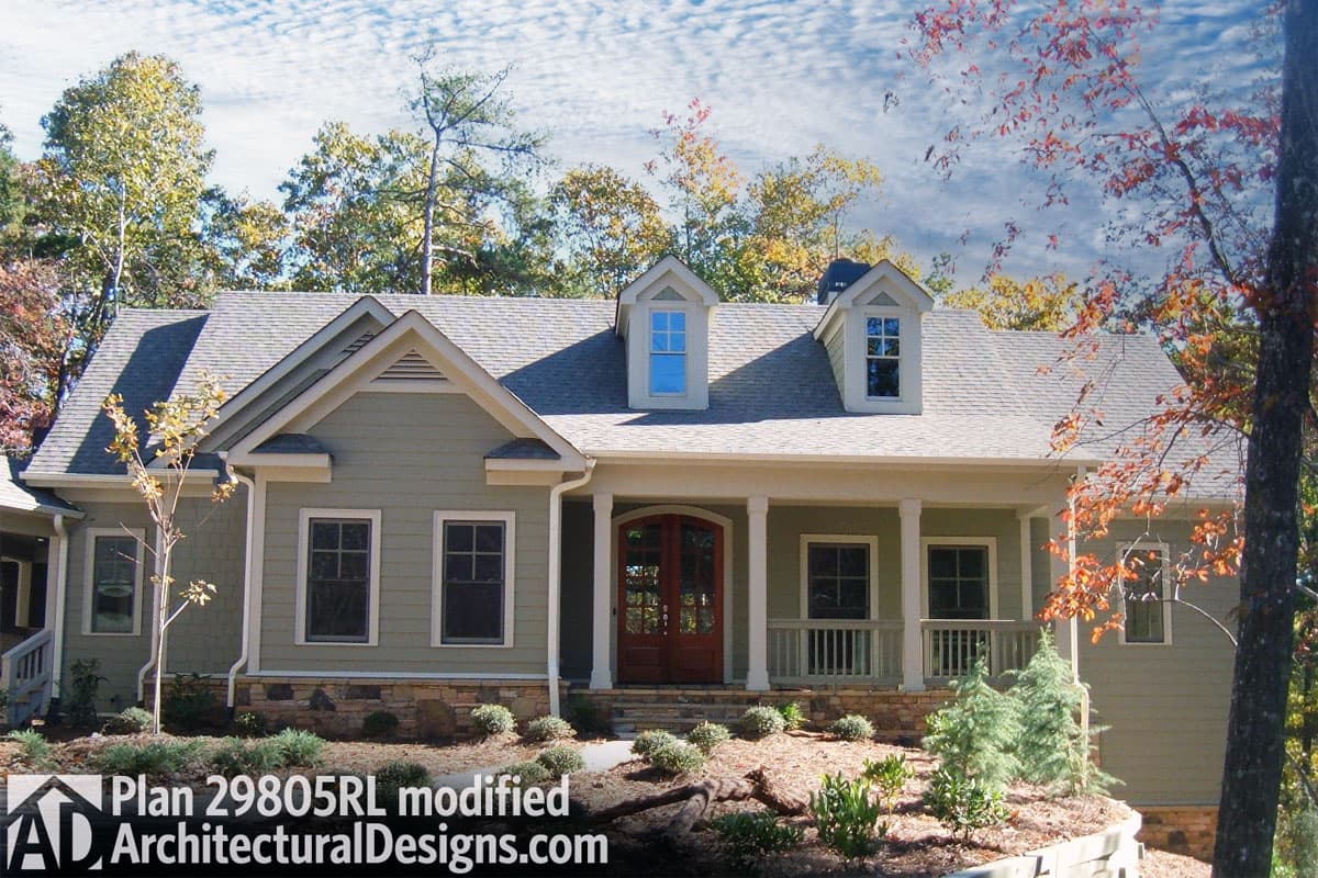 House plan exterior: One-story Modern Farmhouse with covered front porch, double entry doors, two dormers, and stone foundation.