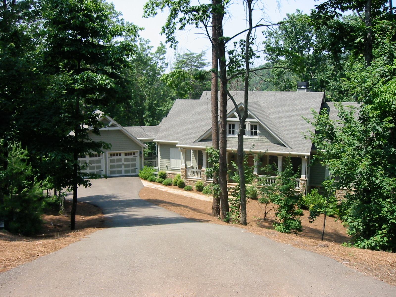 Craftsman style house plan exterior with a side-entry garage, gabled dormers, and a wrap-around porch.