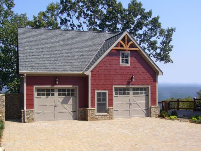 House plan exterior: Rustic modern garage with two bays, shingle siding, stone accents, gable vent, and stone-clad pillars.