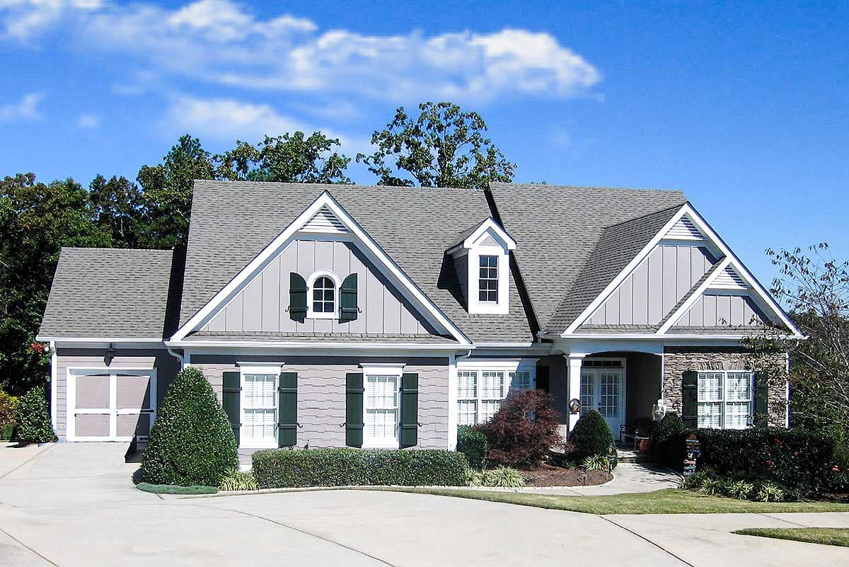 House plan exterior with a two-story Modern Farmhouse style, featuring dormers, gables, stone accents, and a two-car garage.
