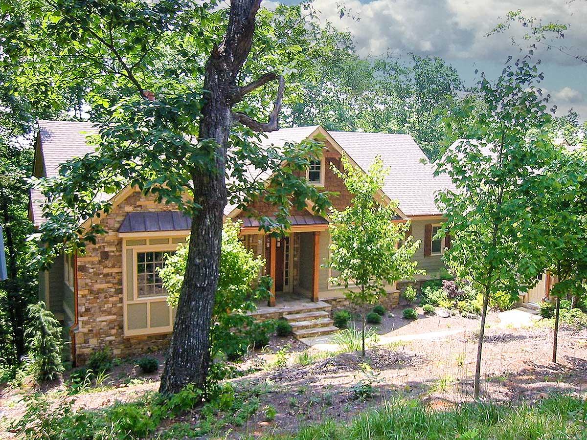 House plan exterior with stone accents, a covered porch with wood columns, and multiple gables.