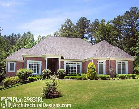House plan exterior: Ranch style, brick facade, hipped roof with gables, prominent covered entry, and many windows.