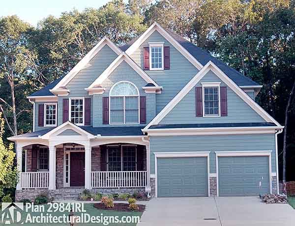 House plan exterior: Two-story home with covered front porch, multiple gables, arched window, and attached two-car garage.