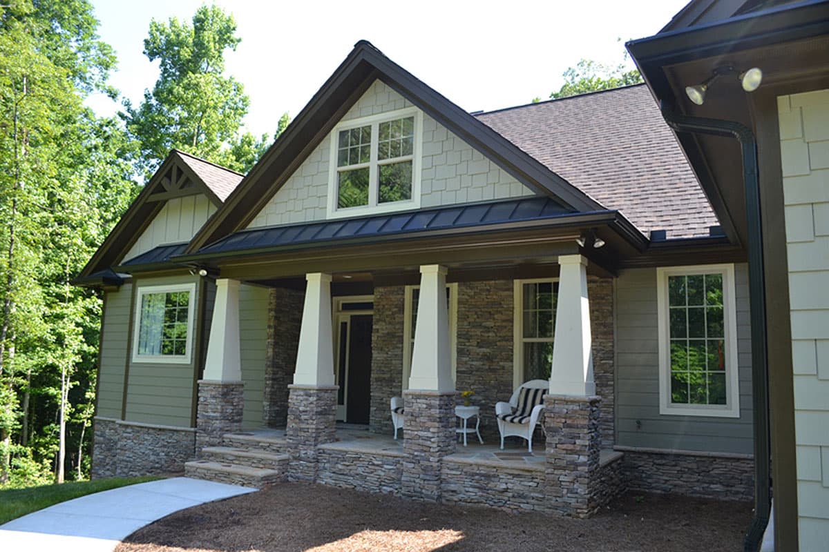 House plan exterior: Modern Farmhouse style with a covered porch, stone accents, gables, and dormer.