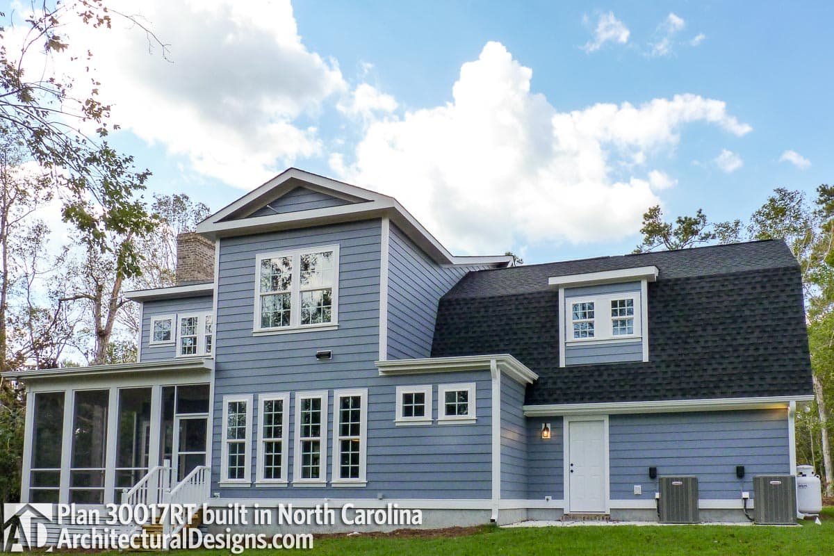 House plan exterior shows a two-story blue home with a screened porch, multiple gables, and a dormer.