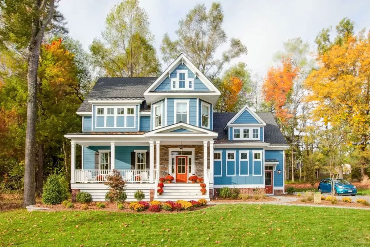 House plan exterior featuring a two-story Craftsman style home with gables, a covered porch, and a hipped roof. Blue siding with white trim.