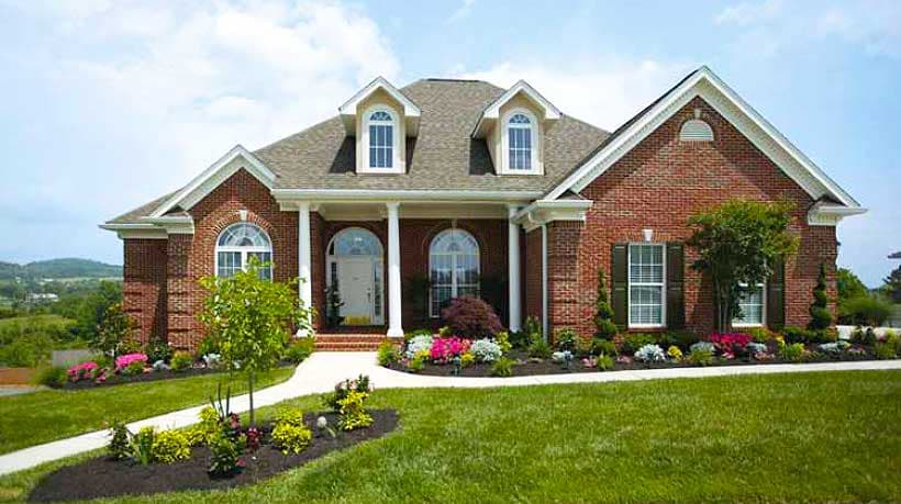 House plan exterior: brick, two-story, covered porch with columns, arched dormers, and arched windows.