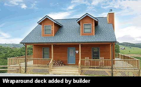 House plan exterior: two-story cabin with wood siding, prominent dormers, and a wraparound deck.