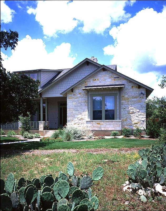 House plan exterior: Two-story stone house with shingle siding, gables, dormers, and a covered porch.
