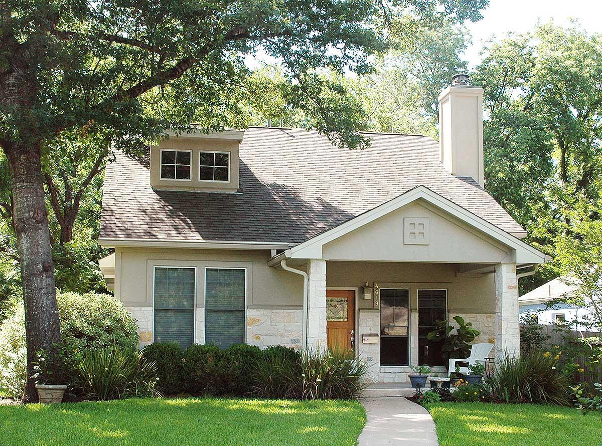 House plan exterior: two-story, gabled roof, dormer window, stone facade accents, and covered front porch.