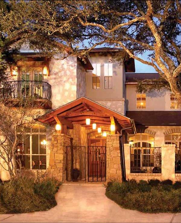House plan exterior with stone accents, a covered wood-beam entryway, and a second-story balcony.