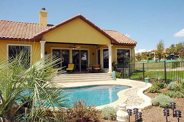 House plan exterior: Mediterranean style, single-story, with tiled roof, covered patio, and swimming pool.