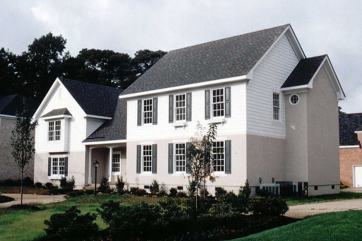House plan exterior: Two-story home with a mix of siding and stucco, front porch, bay window, and multiple gables.
