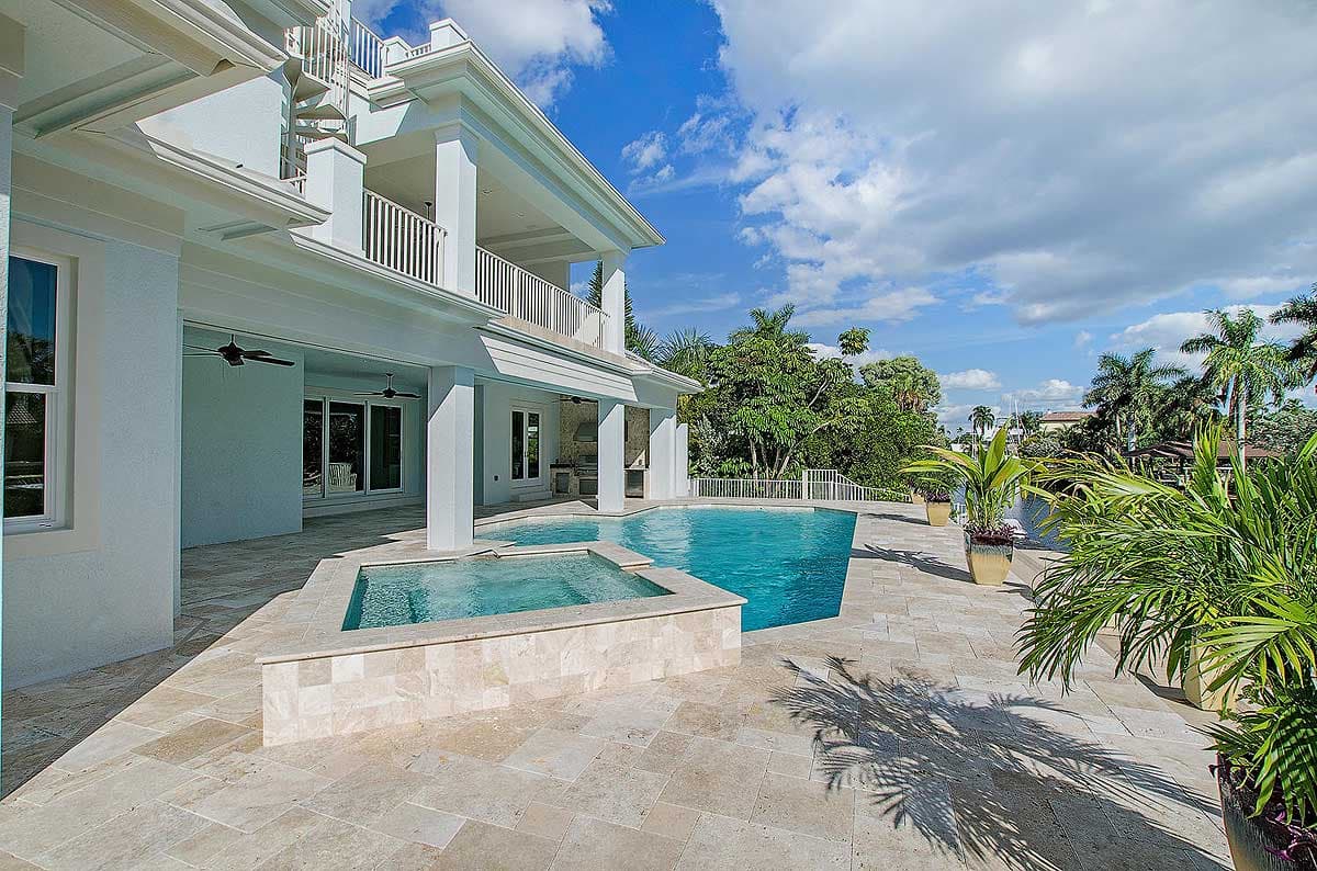 House plan exterior: Modern style, two-story, featuring a spiral staircase, covered balconies, and a courtyard pool.