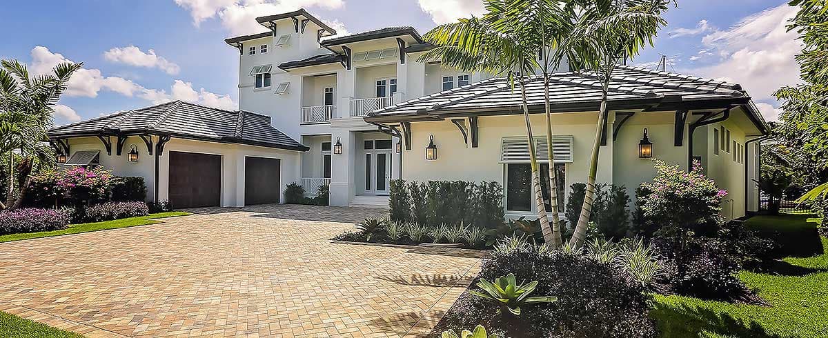 Modern style house plan exterior with three stories, balconies, and a three-car garage.