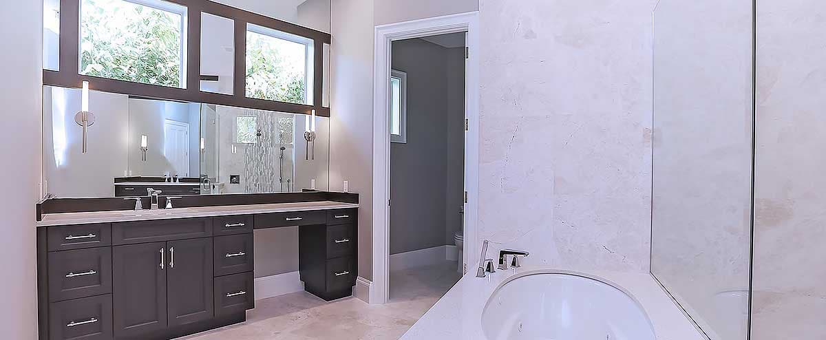Interior rendering of a bathroom with a double vanity, large mirror, and soaking tub, featuring marble walls and tiled shower.