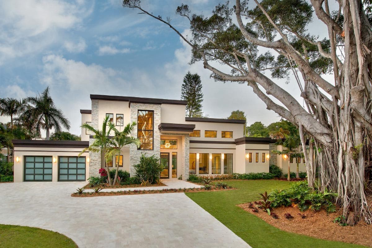 Modern house plan exterior with a two-car garage, large vertical windows, stone accent walls, and a flat roof.