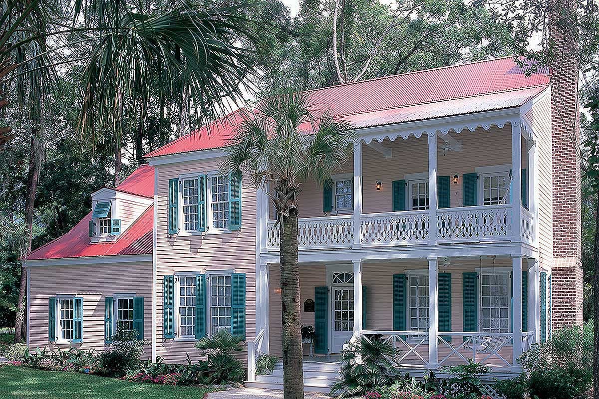 House plan exterior: Two-story Southern vernacular style with wrap-around porches, red metal roof, green shutters, and brick chimney.