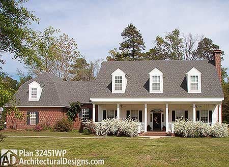 House plan exterior: Two-story brick and siding home with a wraparound porch, multiple dormers, and a prominent central gable.