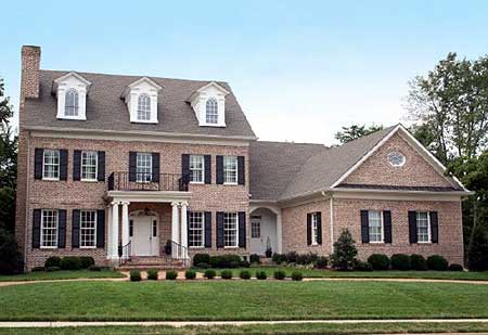 House plan exterior: Two-story brick residence with a central entrance, portico, dormers, and arched gable window.