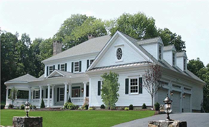 House plan exterior featuring a wrap-around porch, multiple gables, dormers, and a three-car garage.
