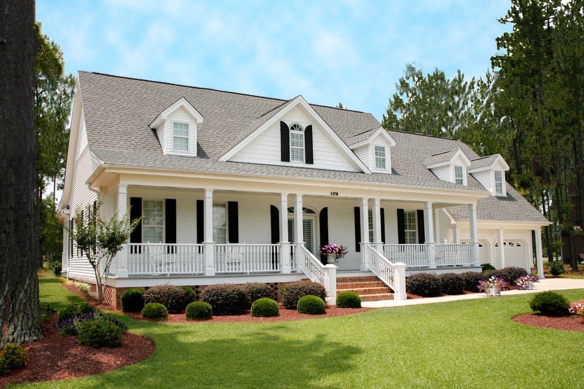 House plan exterior: Southern ranch style, one story, full-width covered porch with columns, dormers, and attached two-car garage.