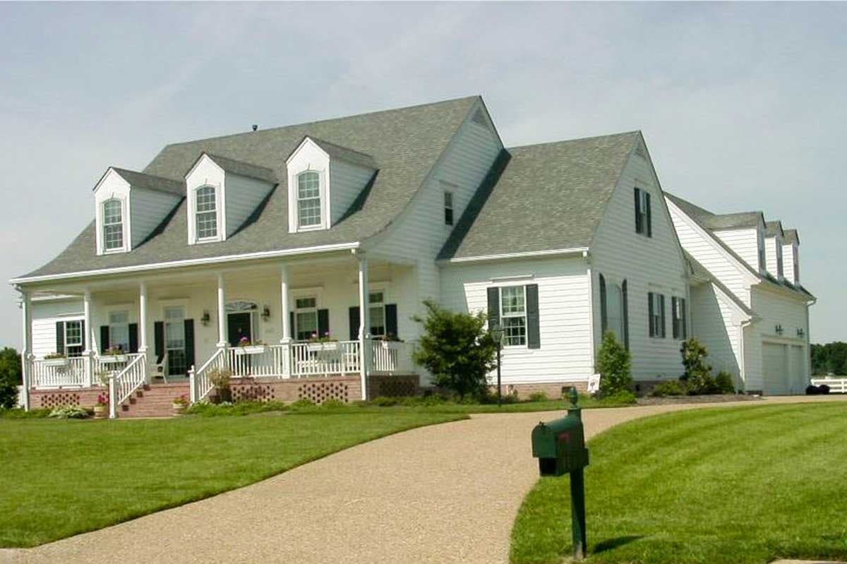 House plan exterior featuring a two-story Colonial style with a wraparound porch, multiple dormers, and a gabled roof.