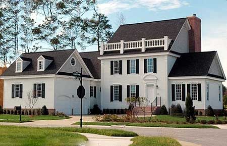 House plan exterior: Colonial style, two stories, symmetrical facade, dormers, and prominent brick chimney.