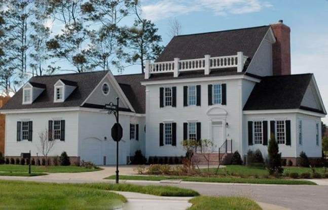 House plan exterior: White two-story home with dormers, multi-level rooflines, and attached garage.