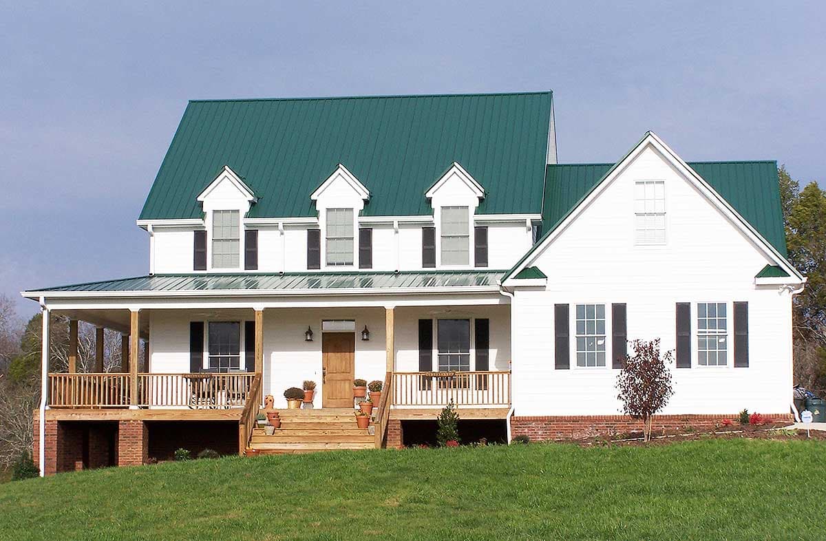 House plan exterior: Two-story Modern Farmhouse with a wraparound porch, gables, and a prominent dormer.
