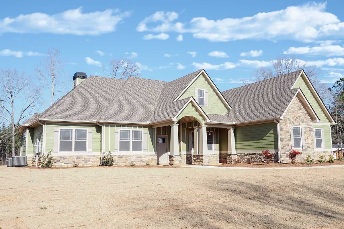 House plan exterior: Ranch style with stone accents, covered front entry with columns, and multiple gables.