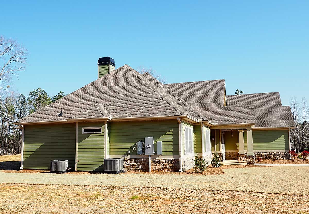House plan exterior: Ranch style, single story, with stone accents, gabled roof, and covered front porch.