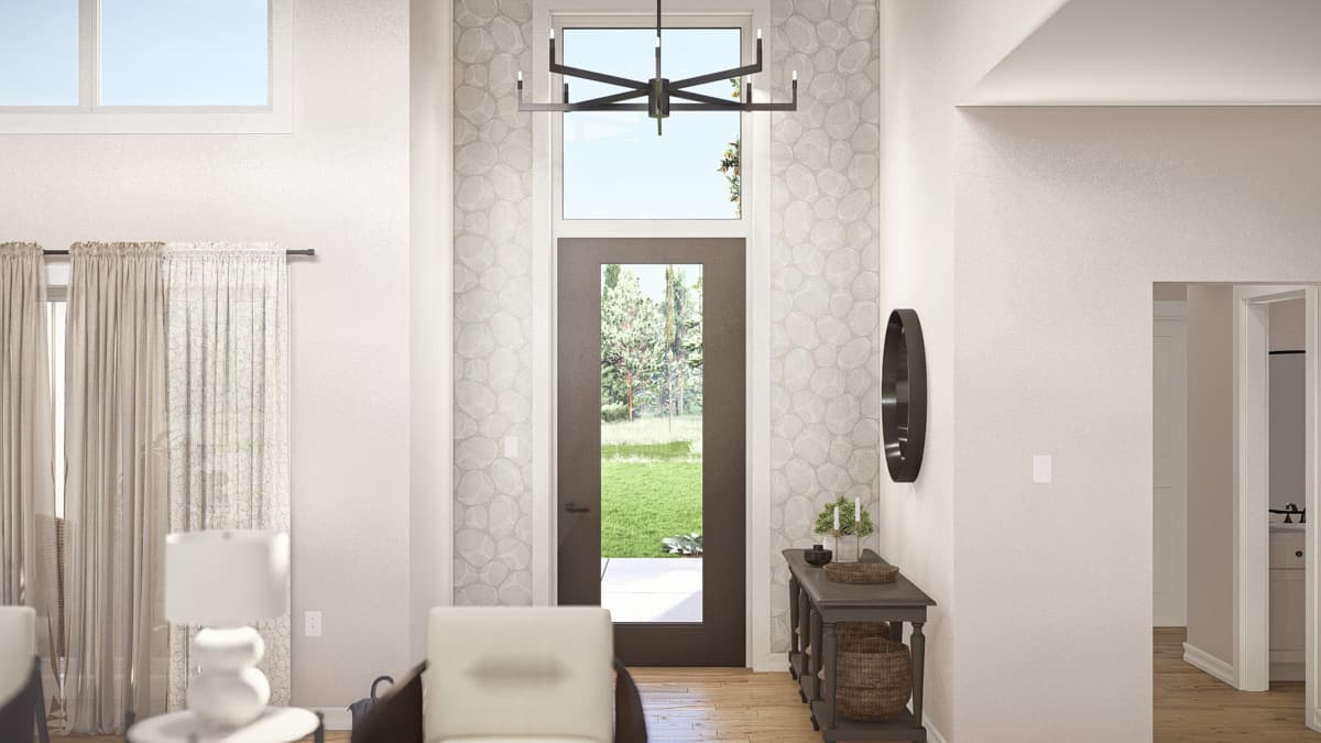 Interior view of modern entryway with tall windows, modern chandelier, and dark door with natural light.