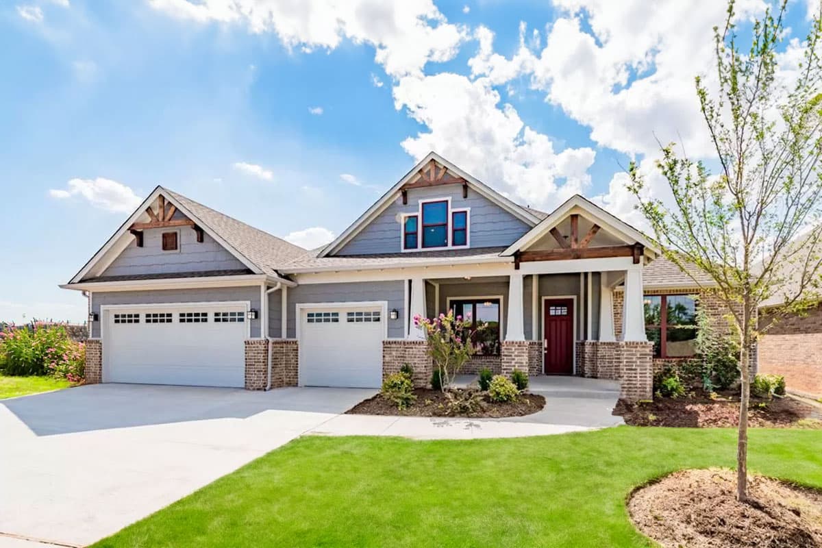 House plan exterior. Craftsman style, single-story home with a gabled roofline, front porch, and two-car garage.