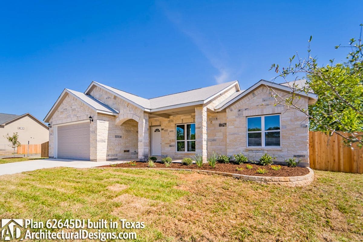 House plan exterior with stone facade, covered entry with arched opening, gable roofs and attached two-car garage.