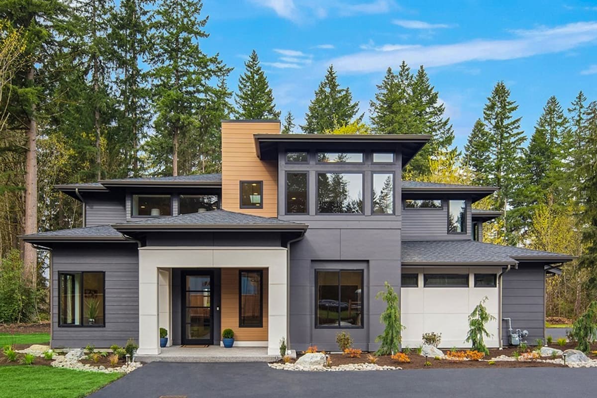 Modern house plan exterior with two stories. Features include a flat roof, large windows, and a covered entry. Garage appears on side.