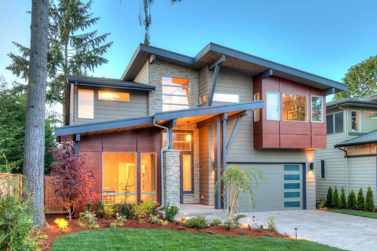 Modern house plan exterior with two stories, flat roof, and a covered entry. Features include stone accents, and a front-facing garage.