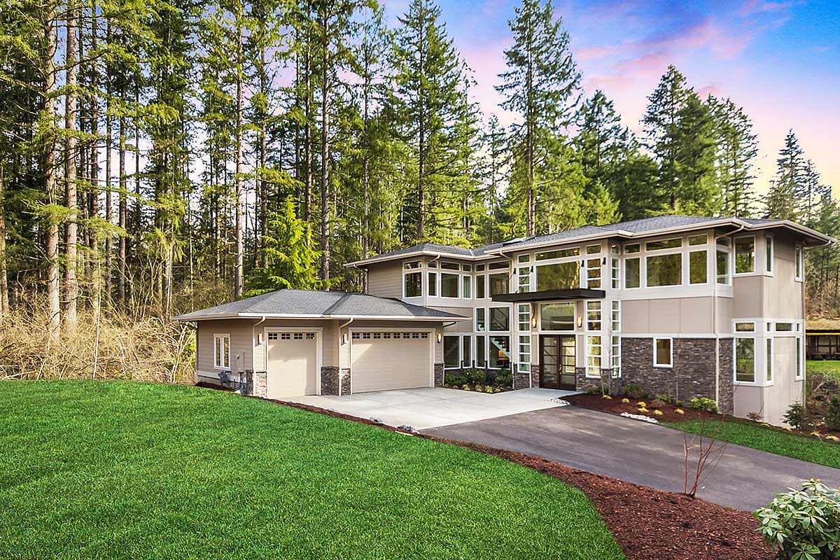 Modern style house plan exterior with a two-car garage, multiple gables, and extensive window walls.