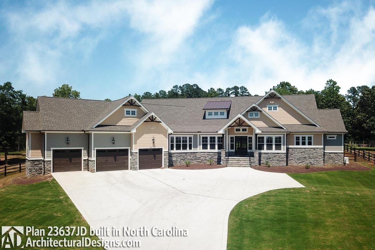 House plan exterior: Modern Farmhouse style, one story, with a three-car garage, prominent gables, and stone accents.