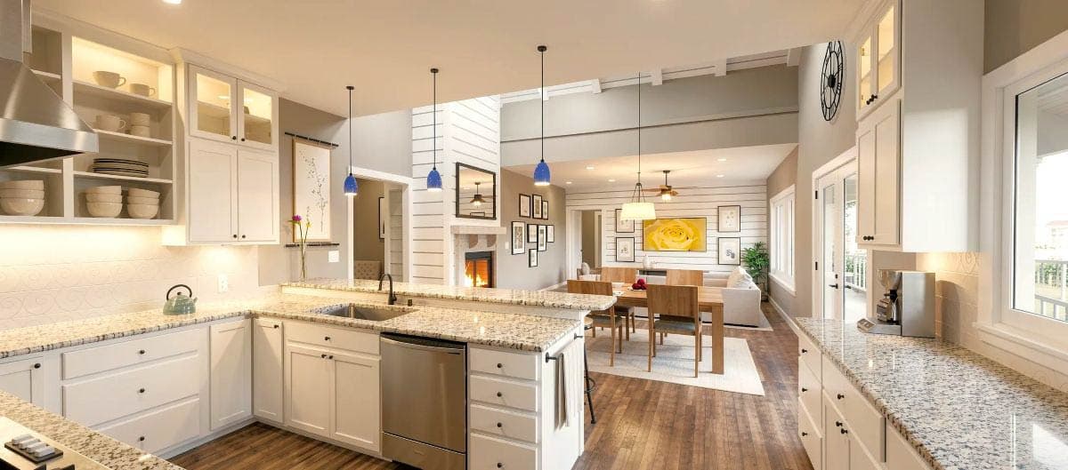 Kitchen and dining area with white cabinetry, granite countertops, fireplace, and wood-paneled walls.