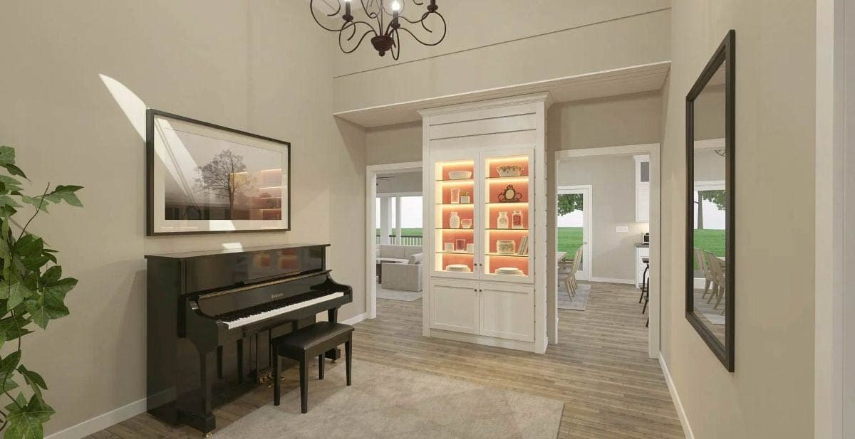 Open-concept living and dining area with fireplace, large windows, and view into modern kitchen with island.