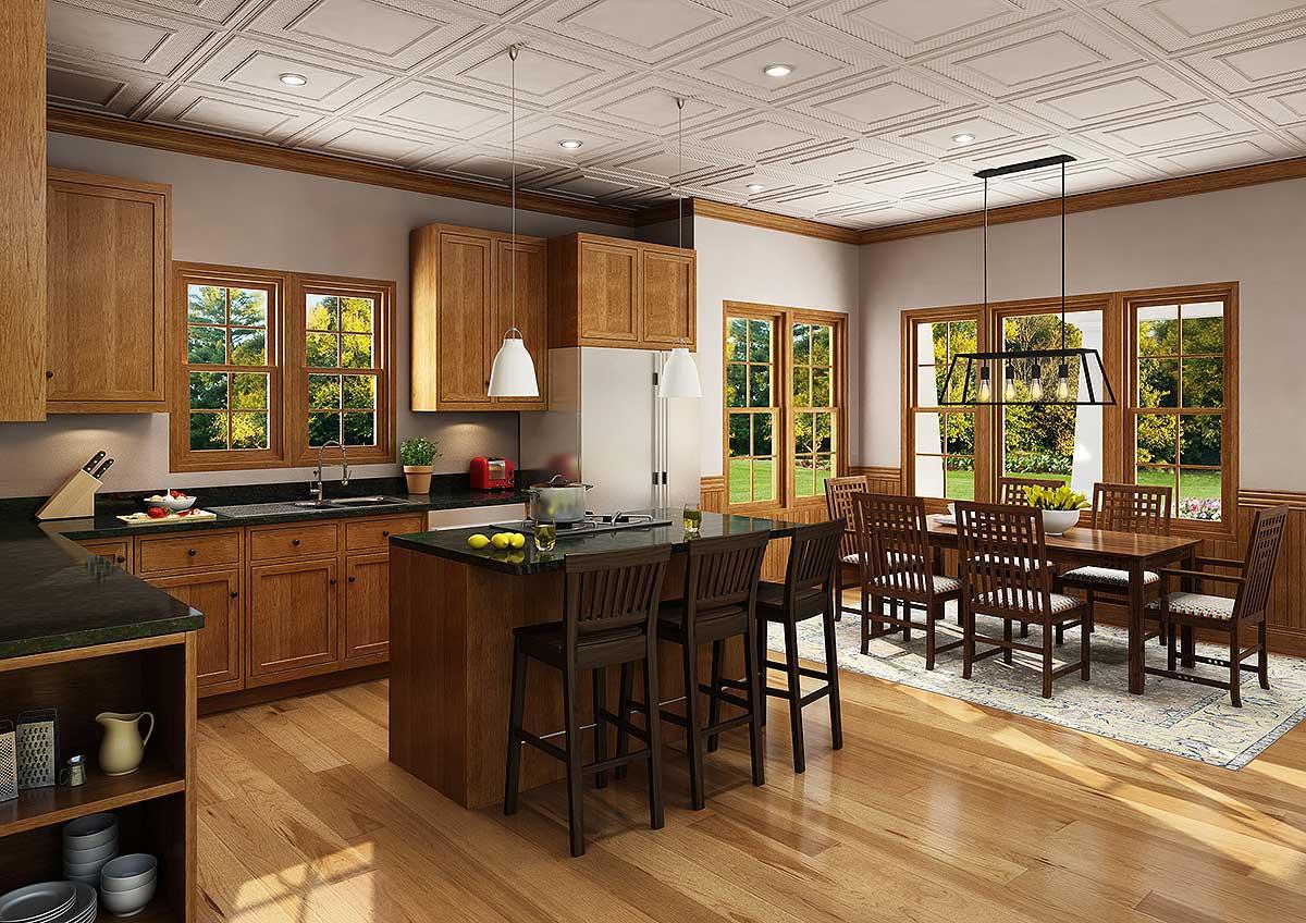 Kitchen and dining area with wood cabinets, island with bar stools, dining table, and large windows.